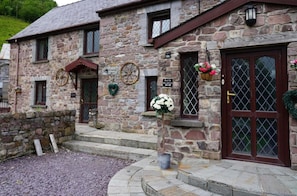 A stone building with a sign reading "Bed & Breakfast." - Pentre Riding Stable and Accommodation (Swansea)