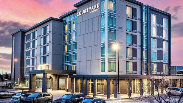 A modern hotel with a flat roof, large windows, and a sign reading "Courtyard by Marriott". - Courtyard by Marriott Burlington (Burlington)