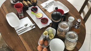 Ein Holztisch mit verschiedenen Speisen, Besteck und Gewürzen.