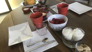 Una mesa de comedor con diversos alimentos y utensilios.