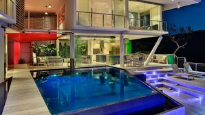 A modern two-story house with a swimming pool, outdoor seating, and a balcony. - The Malinche Palace (Sardinal)