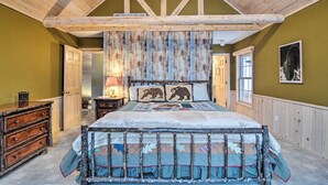 A bedroom with a wooden ceiling, a bed with a quilt, a dresser, and a window. - 2 Mi to Schuss Mtn! Northern Retreat w/ Game Room (Bellaire)