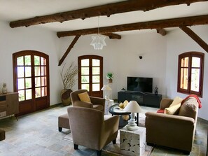 A living room with a television, sofas, a coffee table, and a fireplace. - Prestige Villas | EAST COAST | Villa with Infinity Pool & Stunning View (Corfu)
