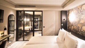 A modern hotel room with a large bed, a desk, and a bathroom visible through an open door. - Hotel Silken Saaj Las Palmas (Las Palmas de Gran Canaria)