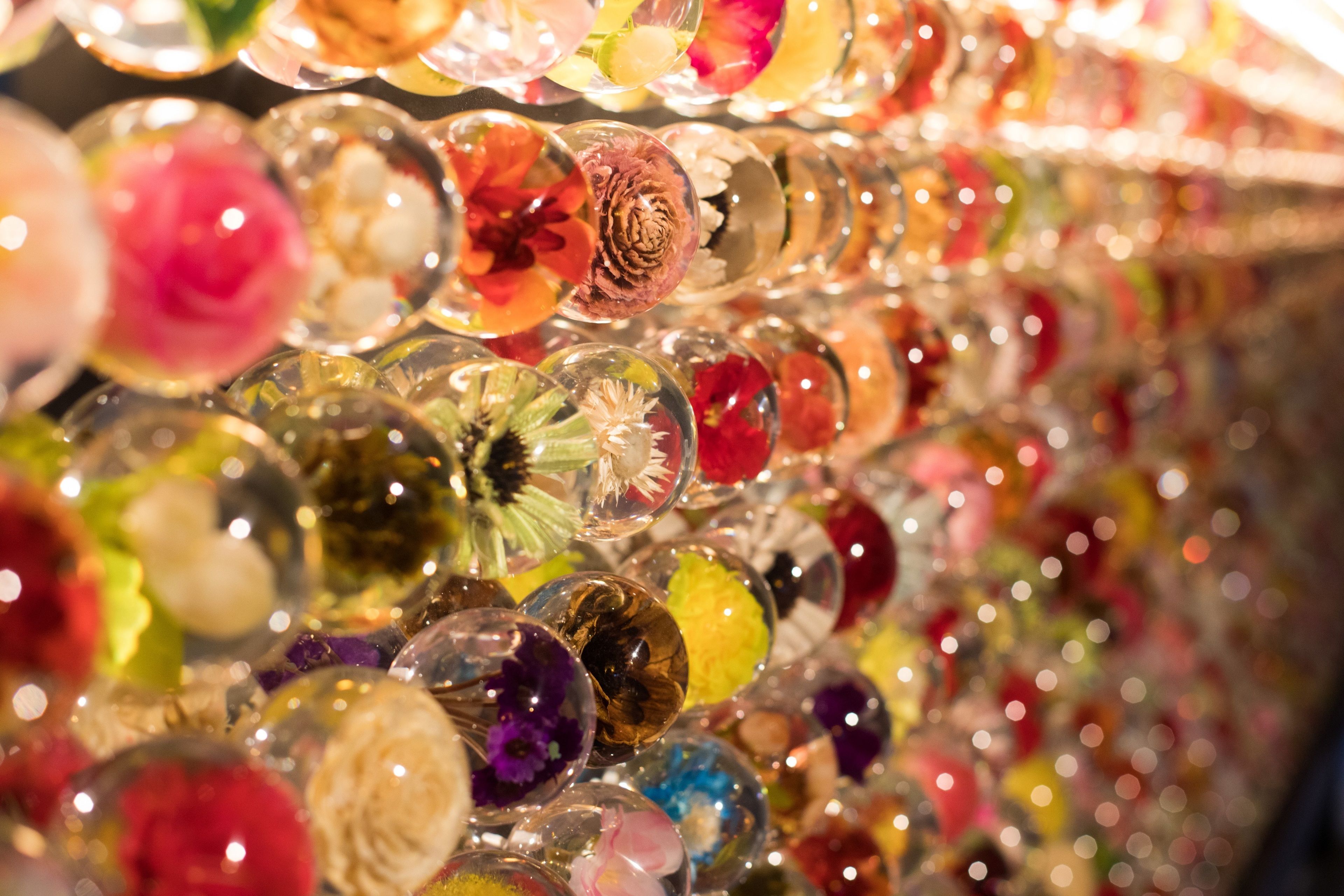 A collection of clear glass ornaments with various floral designs.