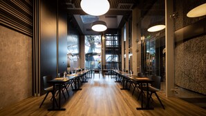 A conference room with long tables, chairs, and pendant lighting. - Hotel Silken Saaj Las Palmas (Las Palmas de Gran Canaria)