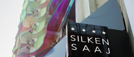 A sign with the text "SILKEN SAJJ" and decorative stars.