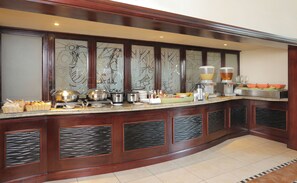 A buffet setup with various food items and kitchen appliances. - Stayeasy Rustenburg (Rustenburg)