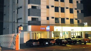 A multi-story hotel with a prominent 'HOTEL' sign at the top.