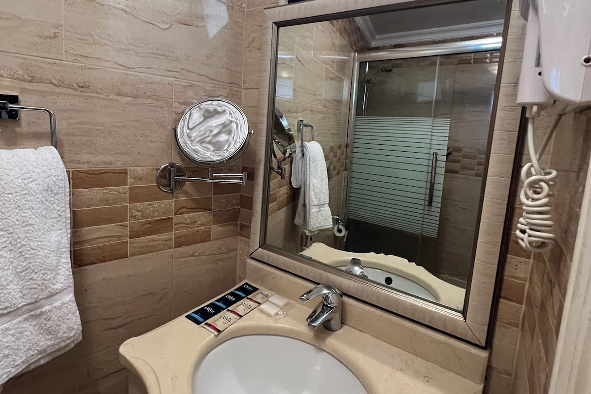 honeymoon room, 1 queen bed | bathroom | rainfall showerhead, free toiletries, hair dryer, slippers