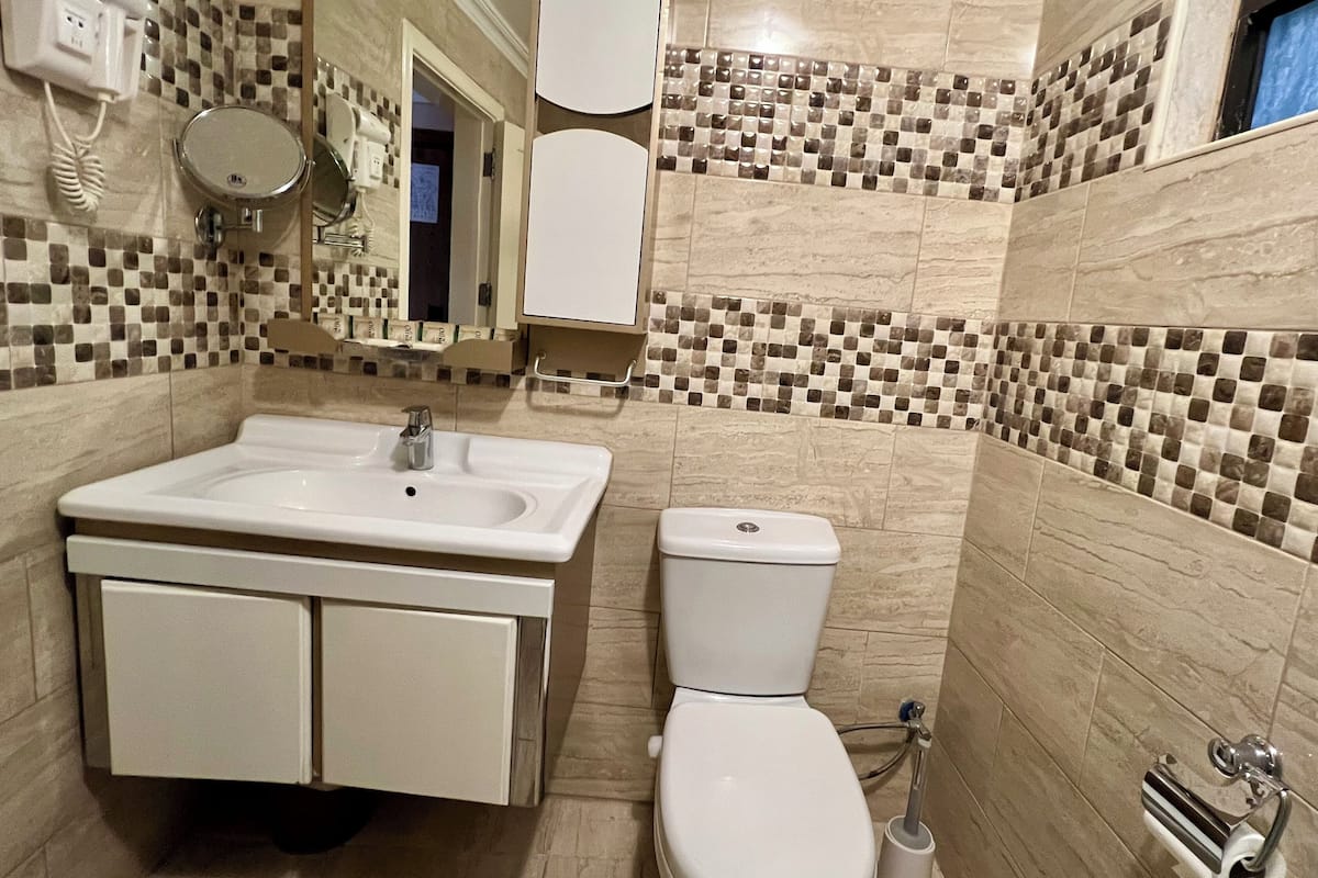 quadruple room | bathroom | rainfall showerhead, free toiletries, hair dryer, slippers
