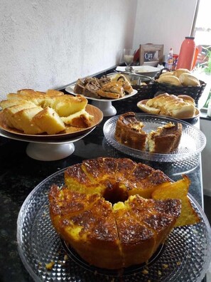 A variety of baked goods displayed on a kitchen counter. - Pousada Aconchego da Chapada (Alto Paraíso de Goiás)