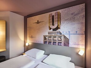 A hotel room with a large bed, a wall-mounted map, and a unique ceiling design. -  B&B HOTEL Dortmund-Airport (Holzwickede)