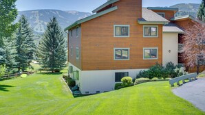 A multi-story wooden house with a sloped roof, surrounded by a well-maintained lawn and trees. - Walk to Beaver Creek Shuttle! Avon Condo w/ Deck (Avon)