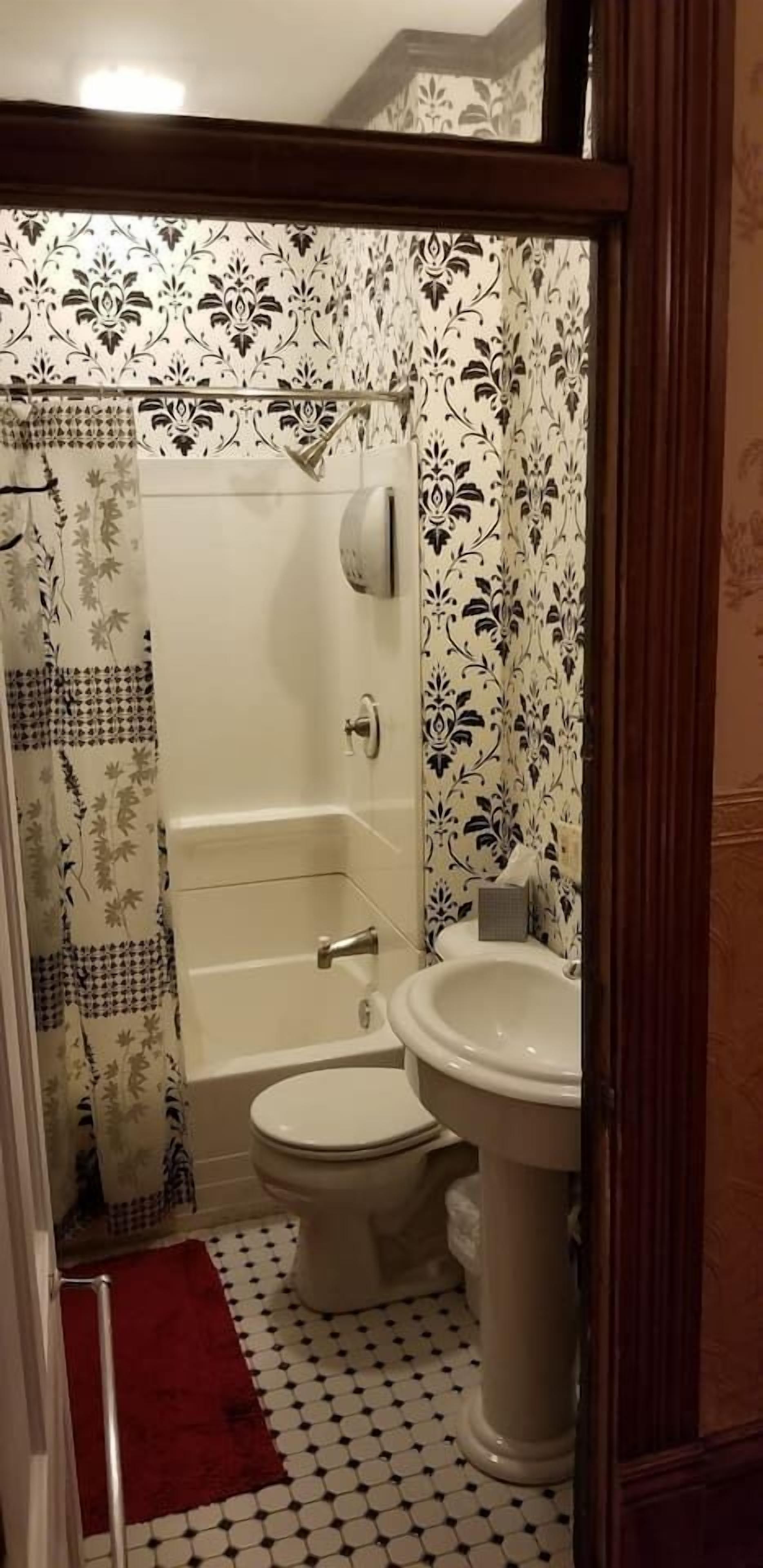 A bathroom with a bathtub, toilet, and sink.