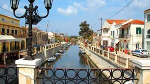 A canal with boats, a bridge with ornate railings, and buildings with balconies and awnings. - In Villa Nikoli private apartment sleeps 5 AMA 223322 (Lefkimmi)