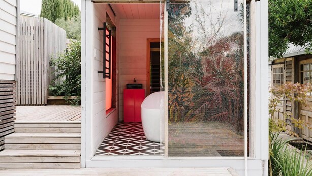 A modern house with a glass door leading to a tiled patio. - The Oxford ~ Hepburn Springs/Daylesford ~ Sleeps 24 (Hepburn Springs)