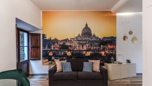 A living room with a large cityscape mural, a dark brown sofa, a green chair, and a white sideboard. - Suite Trastevere San Calisto Rome Historical Center  (Roma)