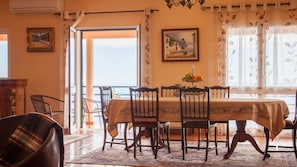 Expansive dining area with ample room for gatherings, featuring tasteful decor and a welcoming atmosphere for enjoyable and memorable dining experiences. #diningroom #oceanview