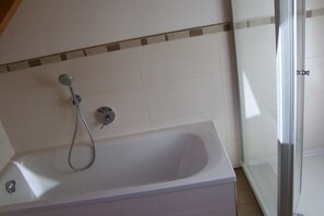 Bathtub, hair dryer, towels, soap