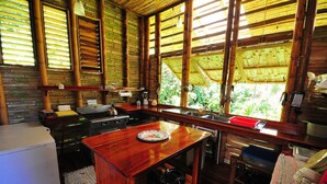 A kitchen with a wooden countertop, stove, and sink. - Casa Piña,  Bamboo Rainforest Beach House (Cabo Matapalo, Peninusla Osa)