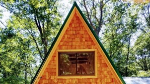 A triangular wooden cabin with a gabled roof, a front door, and two windows. - A-Frame Cabin Escape in George Washington Natl Forest, Lost River Area, WV (Wardensville)