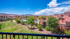 A residential area with houses, a swimming pool, and a clear blue sky. - Poolside Villa | Private Hot Tub | Sleeps 20 | Arcadia #2 (Santa Clara)