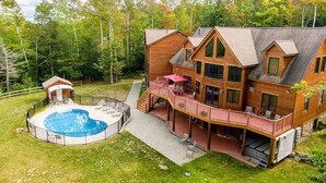 A large wooden house with a hot tub, outdoor seating, and a deck. - RETREAT TO A SECLUDED, SERENE MOUNTAIN LODGE (Bethel)