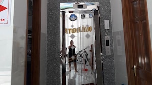 An elevator with a reflective glass door and a decorative design. - Anh Quan Hotel (Quy Nhon Nam)