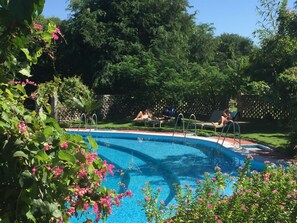 Outdoor pool, open 6:00 AM to 6:00 PM, pool umbrellas, sun loungers