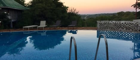 Outdoor pool, open 6:00 AM to 6:00 PM, pool umbrellas, pool loungers