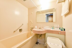 Bathroom features a large bathtub, sink, and toilet, with a mirror above the sink and towel rack on the wall.