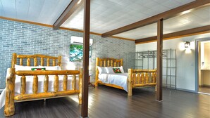 A room with two wooden beds, a brick wall, and a large window. - North Pole Christmas, Michigan Spectacular Lake Superior, Grand Island View! (Christmas)