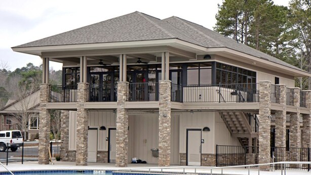 A two-story building with a pool, stone pillars, and balconies. - Keowee Key Townhome - Pet Friendly, View of Golf Course plus Amenities (Salem)