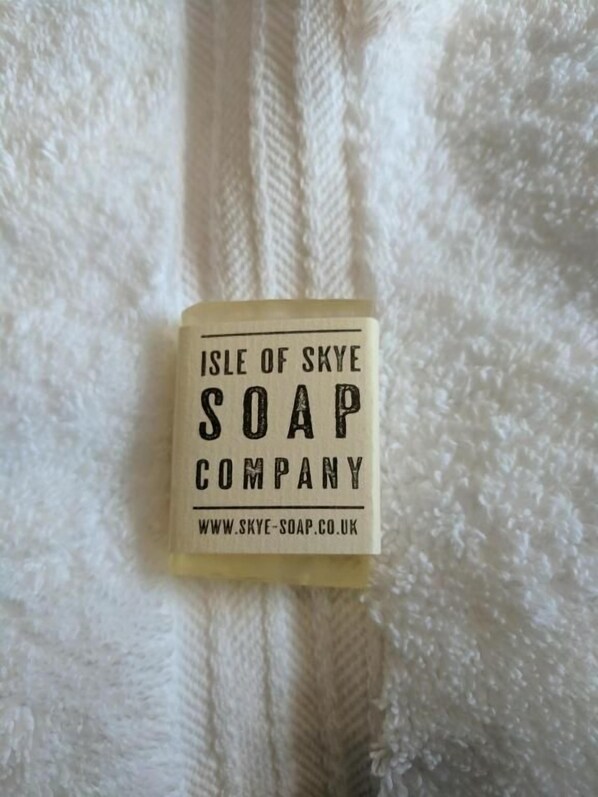 A bar of Isle of Skye Soap Company soap on a white textured surface.