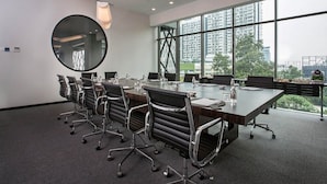A conference room with a long table, multiple chairs, and large windows offering a city view. - Q Stay at Hotel Damansara (Petaling Jaya)