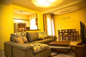 Royal Suite | Living area | 42-inch flat-screen TV with cable channels, TV - Victoria Blue Hotels & Apartments (Kigali)