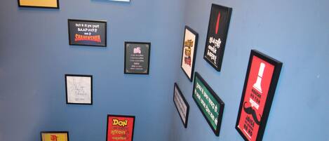 A staircase with a rope barrier and various framed quotes on the wall.