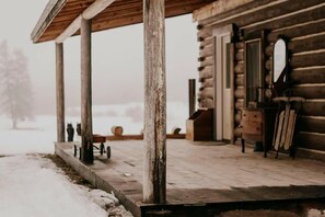 Step out onto the cozy porch and enjoy the serene surroundings.