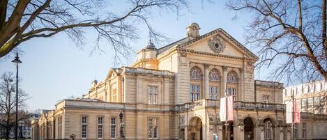 A historic building with classical architecture, featuring a prominent entrance and symmetrical windows.