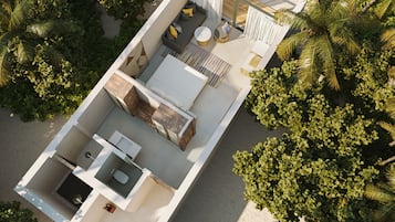 A modern, compact studio apartment with 18 keys and 46 square meters, featuring a balcony with a yellow umbrella, surrounded by lush greenery.