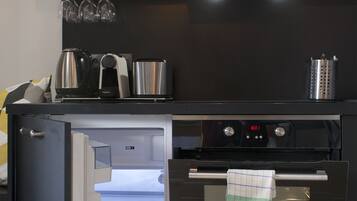 A modern kitchen with a built-in microwave, oven, and refrigerator.