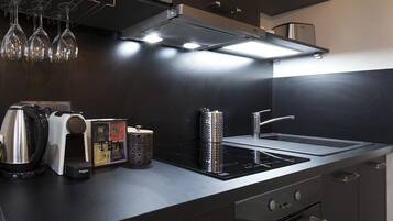 A modern kitchen with a built-in oven, a stovetop, and a microwave.