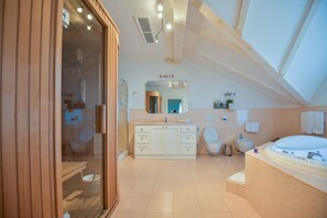 A modern bathroom with a large bathtub, a walk-in shower, and a vanity with a mirror. - Hotel Draga di Lovrana (Lovran)