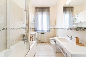 Combined shower/bathtub, bidet, toilet paper