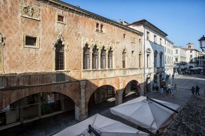 A historic building with arched windows and a courtyard.