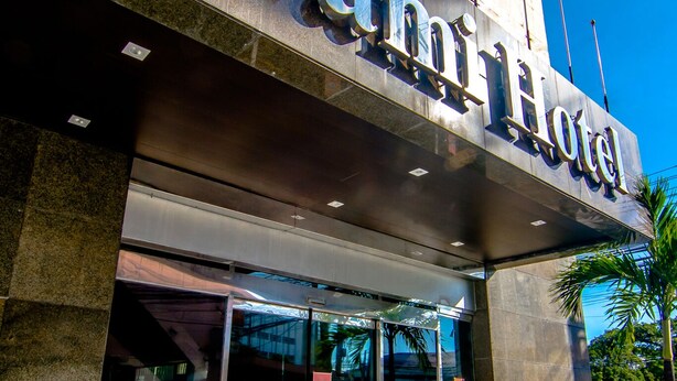 The exterior of the Gram Hotel with a modern design, large glass entrance, and a prominent sign. - DG Grami Hotel (Parañaque)