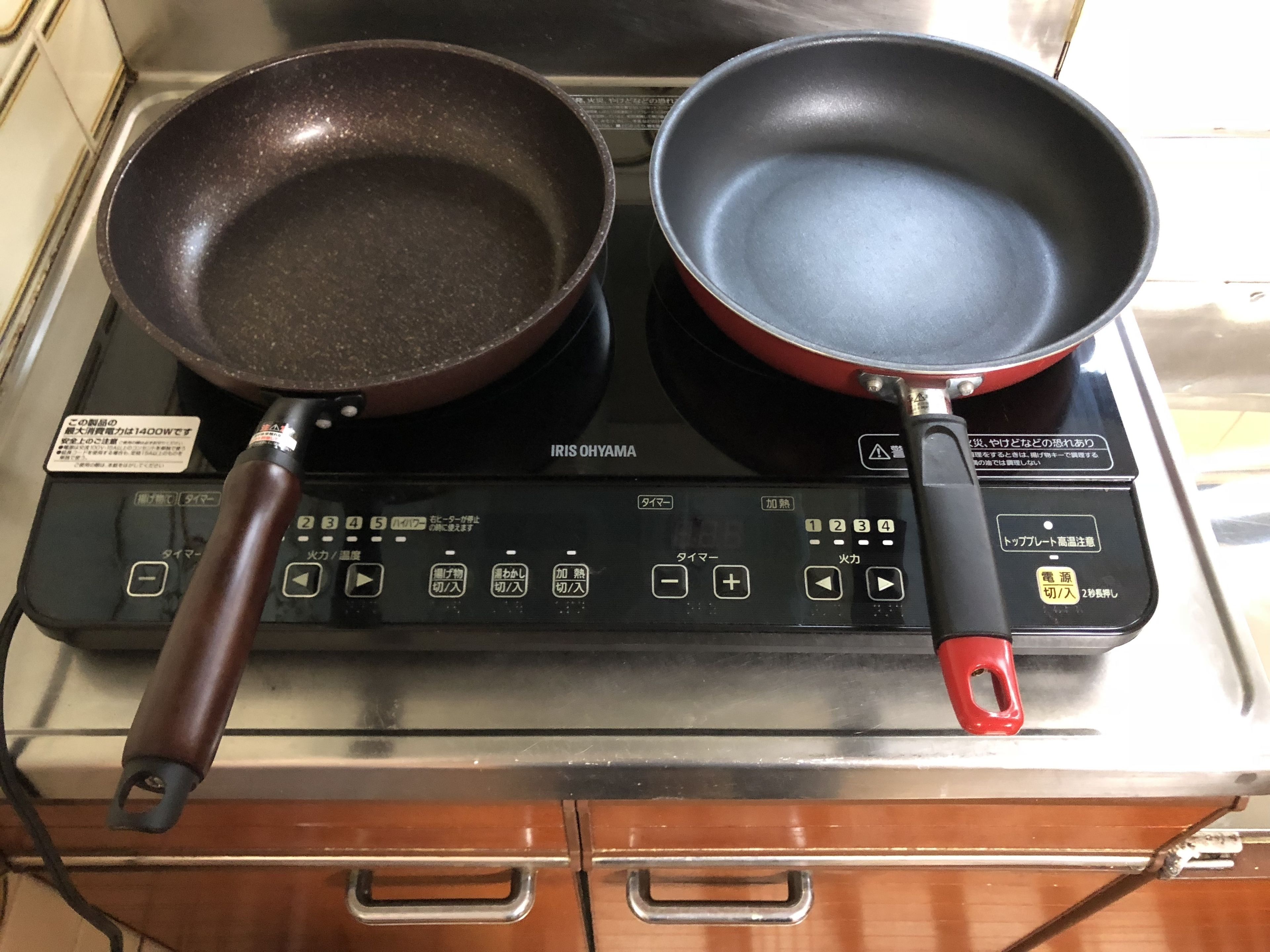 An electric stove with two frying pans on it.