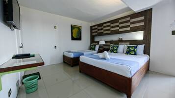 Desk, iron/ironing board, bed sheets