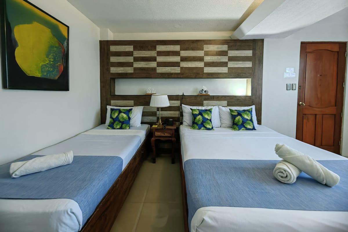 Deluxe Quadruple Room | Desk, iron/ironing board, bed sheets